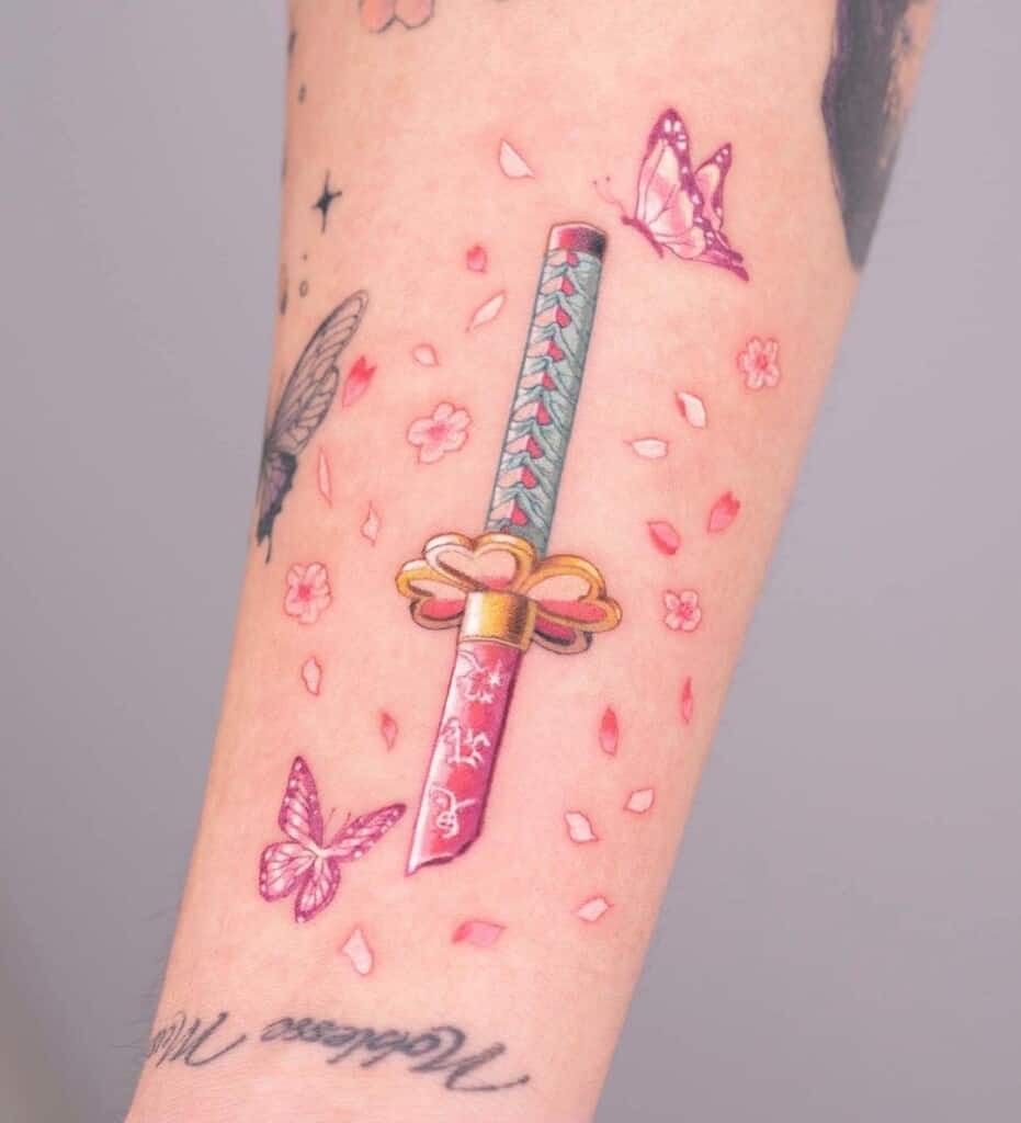 Demon Slayer Nichirin sword tattoo with sakura flowers inner arm