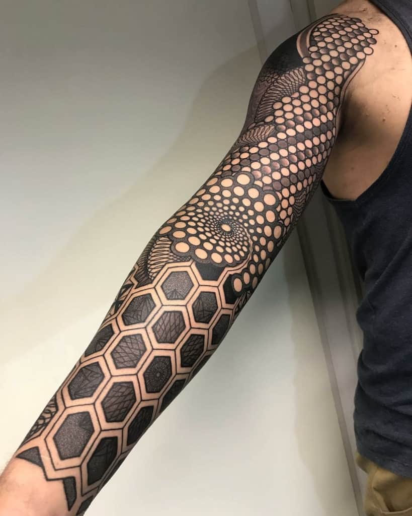Full sleeve sacred geometry tattoo with circle and hexagon focus