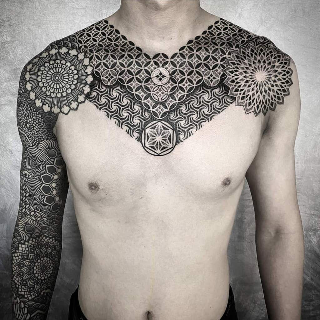 Chest piece geometry tattoo next to the sleeve sacred geometry tattoo