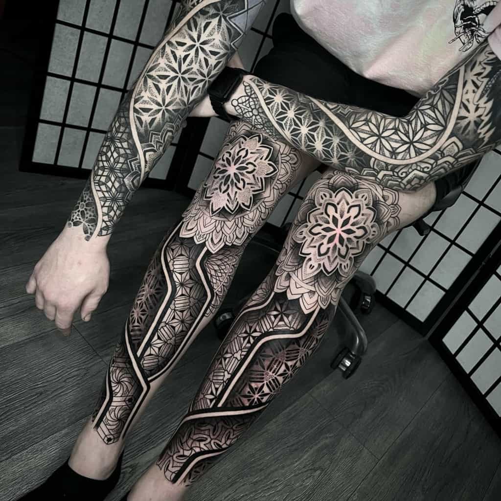 Half a sacred geometry tattoo on both legs and a full sleeve sacred geometry tattoo.