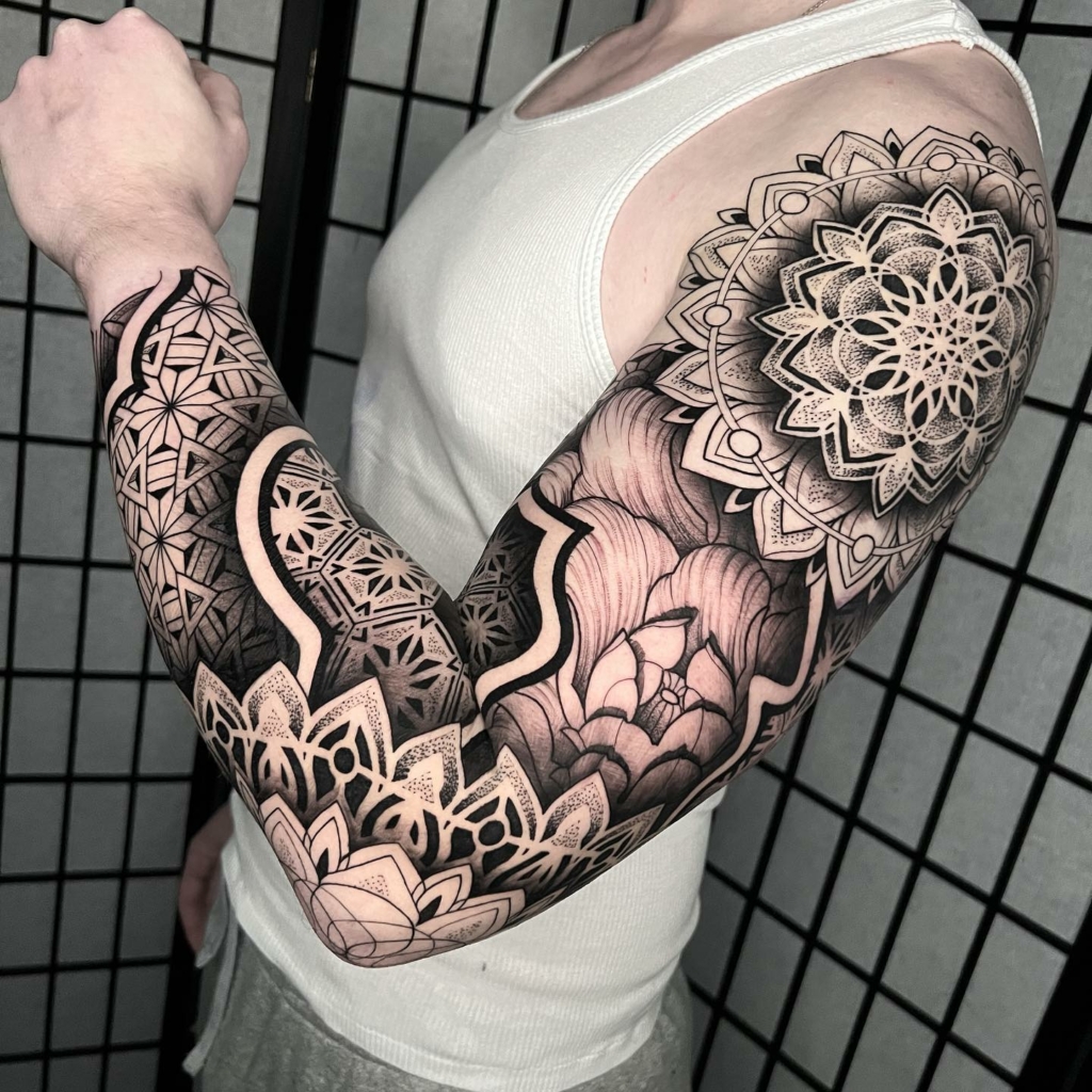 Full sleeve sacred geometry tattoo with dark ink