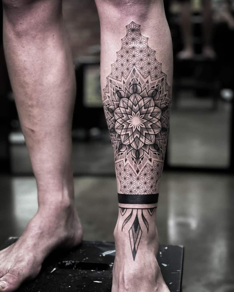 Geometric leg tattoo with floral pattern